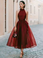 Elegant Sleeveless Halter Midi Dress With Flowing Skirt
