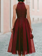 Elegant Sleeveless Halter Midi Dress With Flowing Skirt